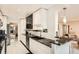Modern kitchen boasts sleek white cabinets, black granite countertops, and updated appliances at 7865 E Mississippi Ave # 1501, Denver, CO 80247