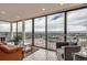 Bright living room featuring city views through floor-to-ceiling windows and modern seating at 7865 E Mississippi Ave # 1501, Denver, CO 80247
