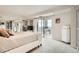 Bright bedroom with balcony access, mirrored closet, and serene city views at 7865 E Mississippi Ave # 1501, Denver, CO 80247
