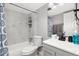 Clean bathroom with marble-look walls and grey vanity at 10211 Ura Ln # 7-108, Thornton, CO 80260