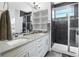 Modern bathroom with double vanity, quartz countertops and glass enclosed shower at 12497 W Virginia Ave, Lakewood, CO 80228