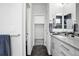 Sleek bathroom with modern vanity, shower and neutral colored tiling at 12497 W Virginia Ave, Lakewood, CO 80228