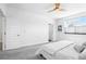 Bright bedroom featuring neutral walls, large window and ceiling fan at 12497 W Virginia Ave, Lakewood, CO 80228