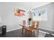 Bright and airy dining room featuring a stylish chandelier, and a modern glass-top table with seating for four at 12497 W Virginia Ave, Lakewood, CO 80228