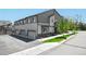 Attractive townhome exterior with a well-kept lawn and a tree providing curb appeal at 12497 W Virginia Ave, Lakewood, CO 80228