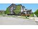 Lovely townhome features a well-maintained lawn, a charming patio, and modern architectural design at 12497 W Virginia Ave, Lakewood, CO 80228