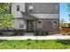 Attractive townhome featuring a modern front entrance with stylish brick accents, and lush green lawn at 12497 W Virginia Ave, Lakewood, CO 80228