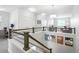 Upper-level hallway with metal railings, an office space, and a view of the living area at 12497 W Virginia Ave, Lakewood, CO 80228