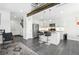 Modern kitchen featuring stainless steel appliances, sleek cabinetry, and an open layout to the living area at 12497 W Virginia Ave, Lakewood, CO 80228