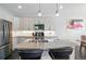 Kitchen island with stainless steel appliances, sleek cabinetry, and modern pendant lighting at 12497 W Virginia Ave, Lakewood, CO 80228