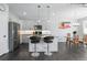 Open-concept kitchen and dining area featuring stainless steel appliances, bar seating, and modern decor at 12497 W Virginia Ave, Lakewood, CO 80228