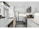 A modern kitchen with stainless steel appliances, sleek cabinets, and a center island with a sink at 12497 W Virginia Ave, Lakewood, CO 80228