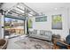 Modern living room featuring a retractable garage door for indoor-outdoor living and designer decor at 12497 W Virginia Ave, Lakewood, CO 80228