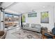 Modern living room featuring a retractable garage door for indoor-outdoor living and designer decor at 12497 W Virginia Ave, Lakewood, CO 80228