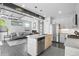 Open-concept living space featuring a modern kitchen with sleek island and a comfortable living room with cozy fireplace at 12497 W Virginia Ave, Lakewood, CO 80228