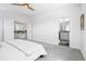 Bright main bedroom featuring neutral walls, ceiling fan and ensuite bathroom at 12497 W Virginia Ave, Lakewood, CO 80228