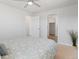 Well-lit bedroom showcasing neutral paint, plush carpet, and easy access to a closet at 306 N 14Th Ave, Brighton, CO 80601