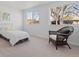 Bright bedroom featuring a sunny window view, stylish chair, and comfortable bed at 306 N 14Th Ave, Brighton, CO 80601
