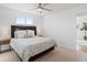 Bright bedroom with a queen-size bed, neutral tones, and a window offering natural light at 306 N 14Th Ave, Brighton, CO 80601