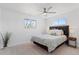 Bright bedroom with a queen-size bed, neutral tones, and a window offering natural light at 306 N 14Th Ave, Brighton, CO 80601