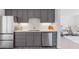 Kitchen featuring gray cabinetry, stainless steel appliances, and a seamless blend with the adjacent living area at 306 N 14Th Ave, Brighton, CO 80601