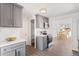 Inviting kitchen featuring gray cabinets, stainless steel appliances, and a view into the light-filled dining room at 306 N 14Th Ave, Brighton, CO 80601