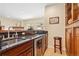 Basement bar with granite countertop and wine cooler at 4619 Mohawk Dr, Larkspur, CO 80118