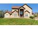 Two-story house with stone accents and a manicured lawn at 4619 Mohawk Dr, Larkspur, CO 80118