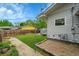 Backyard with a grass lawn, storage shed, and a concrete path at 1202 9Th Ave, Longmont, CO 80501