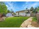 Well-maintained backyard with a storage shed, lush lawn, and deck at 1202 9Th Ave, Longmont, CO 80501