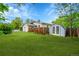 View of the spacious, green backyard featuring a shed and wooden fence at 1202 9Th Ave, Longmont, CO 80501