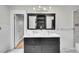 Bathroom featuring a dual sink vanity, tiled floor, and updated fixtures at 1202 9Th Ave, Longmont, CO 80501