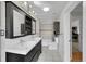 Bathroom with dual sink vanity, tiled floor, and updated fixtures at 1202 9Th Ave, Longmont, CO 80501