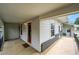 Covered porch with concrete flooring, exterior door, and view of fenced yard at 1202 9Th Ave, Longmont, CO 80501