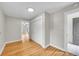 Hallway featuring wood floors, neutral paint, and access to a closet at 1202 9Th Ave, Longmont, CO 80501