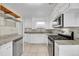 Kitchen features stainless steel appliances, tile backsplash, and white cabinets at 1202 9Th Ave, Longmont, CO 80501