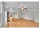 Spacious living room featuring hardwood floors, large windows, and modern ceiling fan at 1202 9Th Ave, Longmont, CO 80501
