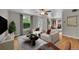 Bright living room featuring a ceiling fan, large window and hardwood floors at 1202 9Th Ave, Longmont, CO 80501