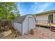 Storage shed next to the deck in the backyard surrounded by wood chips and mulch at 1202 9Th Ave, Longmont, CO 80501