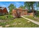 A lush backyard with a brick home, complemented by a stone-lined garden at 2654 Forest St, Denver, CO 80207