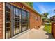 This backyard features a brick exterior and metal security doors at 2654 Forest St, Denver, CO 80207
