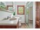 Bright bathroom featuring glass enclosed shower, vanity sink, and natural light at 2654 Forest St, Denver, CO 80207
