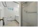 This well-lit bathroom includes a standing shower, toilet and vanity at 2654 Forest St, Denver, CO 80207