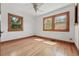 Bright bedroom featuring hardwood floors, two windows, and ceiling fan at 2654 Forest St, Denver, CO 80207