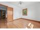 Bedroom features hardwood floors, a ceiling fan, and window views at 2654 Forest St, Denver, CO 80207