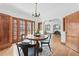 Bright dining area features hardwood floors, French doors, and stylish chandelier at 2654 Forest St, Denver, CO 80207