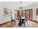 Charming dining room with hardwood floors, chandelier, and views to the kitchen at 2654 Forest St, Denver, CO 80207
