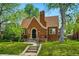 Charming brick home with lush green lawn and mature shade trees at 2654 Forest St, Denver, CO 80207