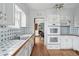 Charming kitchen with white cabinets, blue tiled backsplash, and vintage appliances at 2654 Forest St, Denver, CO 80207
