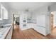 Spacious kitchen features updated appliances, white cabinetry, and tiled countertops at 2654 Forest St, Denver, CO 80207